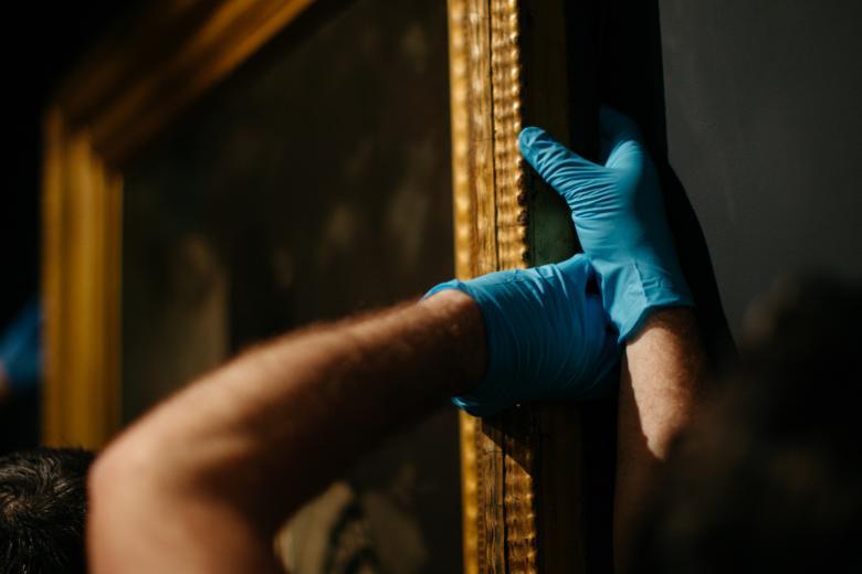 Hanging a painting in the exhibition Margaret Clarke: An Independent Spirit. © National Gallery of Ireland.