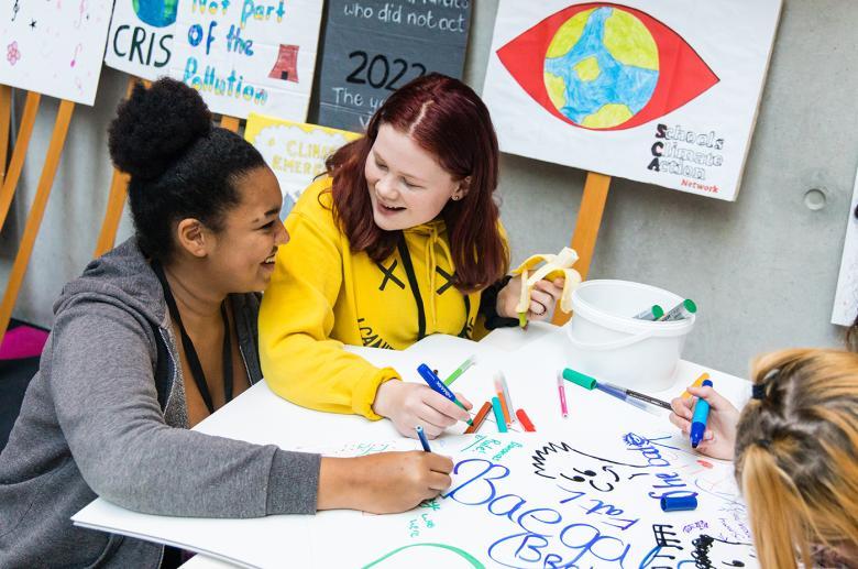 Two teens drawing together at the Creative Schools event in the Gallery