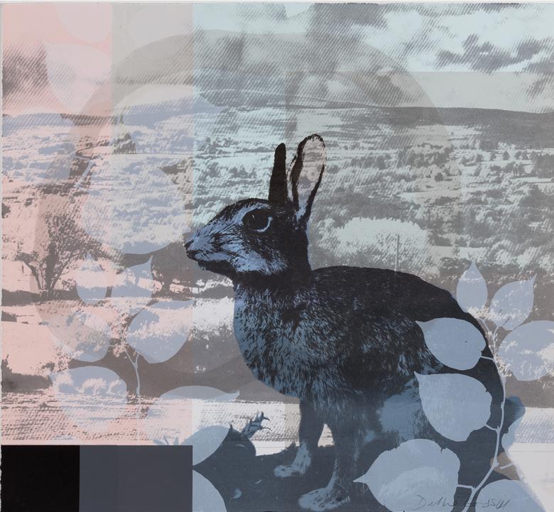 Black and white image of a rabbit on a background of leaves and a rocky landscape.