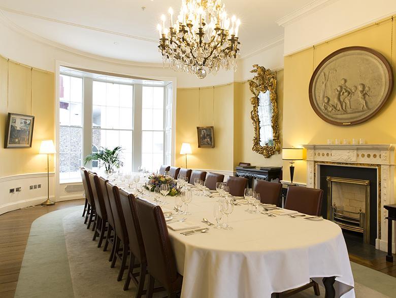 A room with dining table set up for event