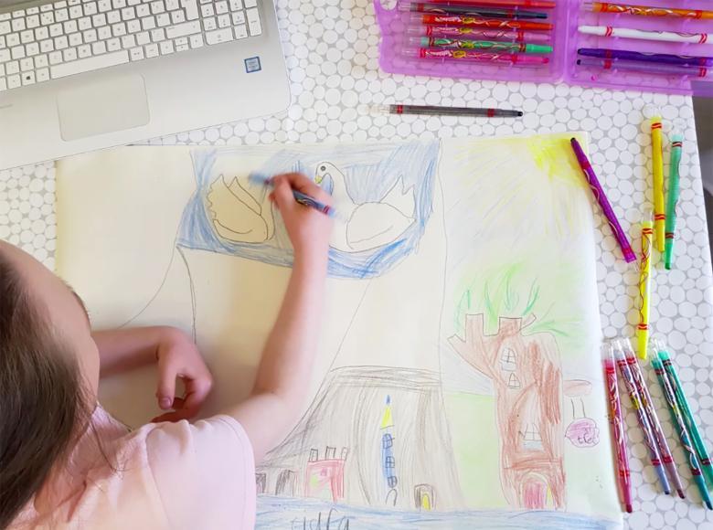 A view from above of a child drawing a picture