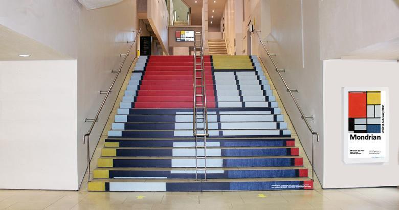 Staircase covered in a image of squares in primary colours by Mondrian.