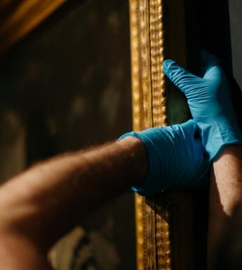 Hanging a painting in the exhibition Margaret Clarke: An Independent Spirit. © National Gallery of Ireland.