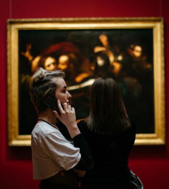 A visitor listening to an audio guide of Beyond Caravaggio. © National Gallery of Ireland.