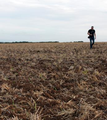 Artist Garrett Phelan recording sound in the field where the Battle of the Somme took place.