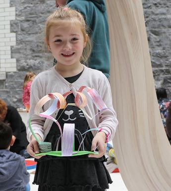 A young girl showing off the artwork that she created at a drop-in family workshop in the National Gallery of Ireland.