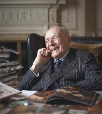 Photographic portrait of Denis Mahon seated at a desk