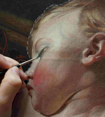 Detail of a figure conserving a painting with a small paintbrush.