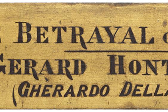 Photo of a nameplate attached to the frame of Caravaggio's painting