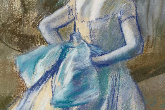 A blue bow on a ballet dancer's costume